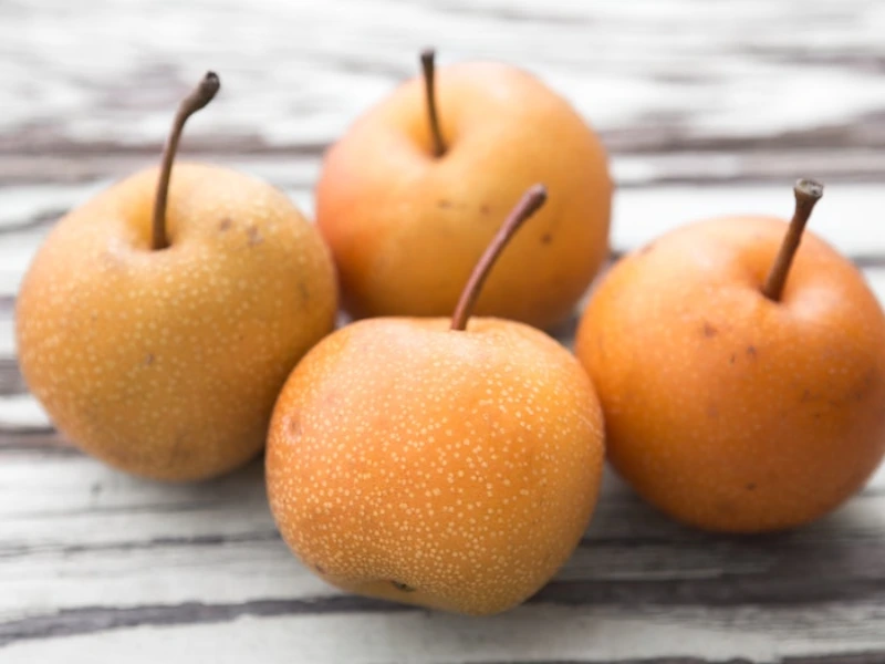 Fresh Shinko Asian pears with their characteristic golden-brown skin, perfect for snacking or cooking
